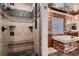 Luxurious bathroom showcasing a walk-in shower with seat, and a soaking tub with stone surround at 7501 Midnight Rambler St, Las Vegas, NV 89149
