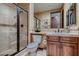 Well-lit bathroom featuring a walk-in shower, vanity with a wood cabinet, and tiled walls at 7501 Midnight Rambler St, Las Vegas, NV 89149