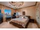Charming bedroom features an artistic ceiling mural, comfortable bed, and natural light at 7501 Midnight Rambler St, Las Vegas, NV 89149