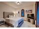 Cozy bedroom featuring a queen-sized bed, neutral tones, and a window with wooden shutters at 7501 Midnight Rambler St, Las Vegas, NV 89149