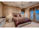 Inviting bedroom with a plush bed, a chandelier, and a view of the outdoors at 7501 Midnight Rambler St, Las Vegas, NV 89149