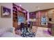 Elegant dining room featuring custom built-ins, a dining table and chairs, and a colorful area rug at 7501 Midnight Rambler St, Las Vegas, NV 89149