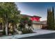Inviting two-story home with a well-manicured lawn, mature trees, and a three-car garage at 7501 Midnight Rambler St, Las Vegas, NV 89149