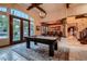 Bright game room with pool table, natural light, and views of the backyard, offering a stylish recreational space at 7501 Midnight Rambler St, Las Vegas, NV 89149