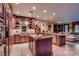 Spacious kitchen featuring stainless steel appliances, a large island, and seamless flow to the living area at 7501 Midnight Rambler St, Las Vegas, NV 89149