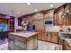 Well-equipped kitchen with granite countertops, a kitchen island, and stainless steel appliances for modern living at 7501 Midnight Rambler St, Las Vegas, NV 89149
