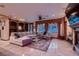 Spacious living room boasts plush sofa, built-in bookcase, fireplace, and large windows at 7501 Midnight Rambler St, Las Vegas, NV 89149