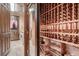 Custom wine cellar with wooden racks, adjacent laundry room with washer and dryer at 7501 Midnight Rambler St, Las Vegas, NV 89149