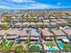 Beautiful aerial view of a neighborhood featuring well-maintained homes, landscaping and backyard pools at 7545 Fontera Ct, Las Vegas, NV 89139
