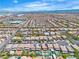 Extensive aerial view of neighborhood homes under a blue sky and wispy clouds showing the interconnected streets at 7545 Fontera Ct, Las Vegas, NV 89139