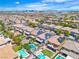 Beautiful aerial view of a neighborhood featuring well-maintained homes, landscaping and backyard pools with Las Vegas skyline in the distance at 7545 Fontera Ct, Las Vegas, NV 89139