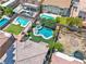 Aerial shot showcases a backyard with a unique pool, spa, manicured lawn, and outdoor entertainment space at 7545 Fontera Ct, Las Vegas, NV 89139