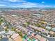 Beautiful aerial view of a neighborhood featuring well-maintained homes, landscaping and backyard pools with Las Vegas skyline in the distance at 7545 Fontera Ct, Las Vegas, NV 89139