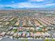 Extensive aerial shot showing numerous homes with pools, and landscaped yards under a clear blue sky in a sunny neighborhood at 7545 Fontera Ct, Las Vegas, NV 89139