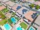 This beautiful aerial view of a two-story home features a unique backyard pool and spa combo along with green landscaping at 7545 Fontera Ct, Las Vegas, NV 89139
