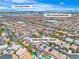 Beautiful aerial view of a neighborhood featuring well-maintained homes, landscaping and backyard pools with Las Vegas skyline in the distance at 7545 Fontera Ct, Las Vegas, NV 89139
