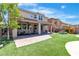 Gorgeous covered patio and outdoor gym with synthetic grass leading to the pool and spa at 7545 Fontera Ct, Las Vegas, NV 89139