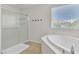 Bright bathroom with a soaking tub, glass-enclosed shower, and dual sink vanity at 7545 Fontera Ct, Las Vegas, NV 89139