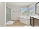 Well-lit bathroom with a glass-enclosed shower, soaking tub, and large vanity at 7545 Fontera Ct, Las Vegas, NV 89139