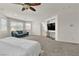 Spacious main bedroom with seating area, ceiling fan, and large windows at 7545 Fontera Ct, Las Vegas, NV 89139