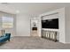 Spacious bedroom featuring a large window and adjacent bathroom entrance, ample natural light, and a modern console at 7545 Fontera Ct, Las Vegas, NV 89139