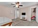 Bedroom featuring a crib, ceiling fan, closet, and a dresser with a television at 7545 Fontera Ct, Las Vegas, NV 89139