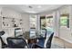 Dining area with modern table, seating, and backyard views at 7545 Fontera Ct, Las Vegas, NV 89139