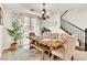 Comfortable dining room with a chandelier, large windows, and seating for six at 7545 Fontera Ct, Las Vegas, NV 89139