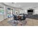 Open dining area with unique table, backyard views, and living room access at 7545 Fontera Ct, Las Vegas, NV 89139