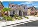 Landscaped front yard with a palm tree of a two-story home featuring a gray stucco and tiled roof at 7545 Fontera Ct, Las Vegas, NV 89139