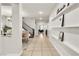 Open foyer showcasing tile floors, a staircase with iron railings, and views into dining and living areas at 7545 Fontera Ct, Las Vegas, NV 89139