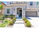 Inviting front porch with a bench, floral wreath, and manicured landscaping leading to the front door at 7545 Fontera Ct, Las Vegas, NV 89139