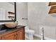 Chic half bathroom features a vessel sink, dark vanity, and decorative mirror at 7545 Fontera Ct, Las Vegas, NV 89139