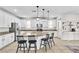Bright kitchen with white cabinets, granite counters, stainless steel appliances, and a large center island with seating at 7545 Fontera Ct, Las Vegas, NV 89139