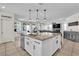 Modern kitchen island with breakfast bar, leading to the living area at 7545 Fontera Ct, Las Vegas, NV 89139