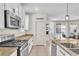 Kitchen featuring stainless appliances, granite countertops, double sink, pantry, and view to the pool at 7545 Fontera Ct, Las Vegas, NV 89139