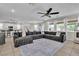 Bright living space with a large sofa, windows, and kitchen view at 7545 Fontera Ct, Las Vegas, NV 89139