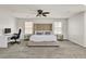 This spacious main bedroom features carpet flooring, ceiling fan and large windows to enjoy the outdoor views at 7545 Fontera Ct, Las Vegas, NV 89139