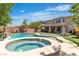 Enjoy this backyard pool and spa with attached covered patio and low maintenance artificial grass at 7545 Fontera Ct, Las Vegas, NV 89139