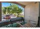 Balcony featuring table, seating, and neighborhood view framed by mature tree at 7885 W Flamingo Rd # 1161, Las Vegas, NV 89147