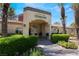 Rancho Viejo Clubhouse exterior view featuring lush landscaping, a tile roof, and an inviting entrance at 7885 W Flamingo Rd # 1161, Las Vegas, NV 89147