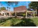 Exterior view of the community featuring a grassy area, covered seating, and mature landscaping at 7885 W Flamingo Rd # 1161, Las Vegas, NV 89147