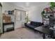 Living room featuring dark futon, work station, and bright window to let in natural light at 7885 W Flamingo Rd # 1161, Las Vegas, NV 89147