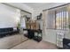 Living room featuring dark futon, work station, and bright window to let in natural light at 7885 W Flamingo Rd # 1161, Las Vegas, NV 89147