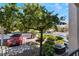 Landscaped street view with mature tree, sidewalk, parked car, and condo building in the Rancho Viejo Community at 7885 W Flamingo Rd # 1161, Las Vegas, NV 89147