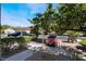 Neighborhood street view featuring mature landscaping, parked cars under covered parking, and a glimpse of nearby buildings at 7885 W Flamingo Rd # 1161, Las Vegas, NV 89147