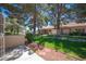 A beautiful backyard with mature trees and well-manicured landscaping offering a serene and private outdoor space at 7911 Canoe Ln, Las Vegas, NV 89145