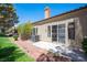 Cozy backyard with minimal landscaping, concrete patio, and security door at 7911 Canoe Ln, Las Vegas, NV 89145