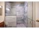 Contemporary bathroom with glass shower door, handrails and custom tile work at 7911 Canoe Ln, Las Vegas, NV 89145