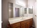 Bathroom with wood vanity, white countertop and a large mirror above the sink at 7911 Canoe Ln, Las Vegas, NV 89145